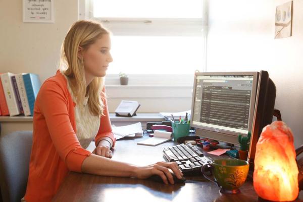 Female student working on computer in her room